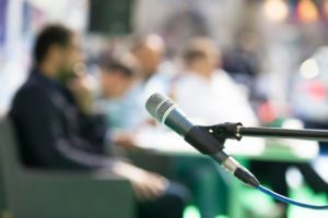 Microphone in focus against blurred people